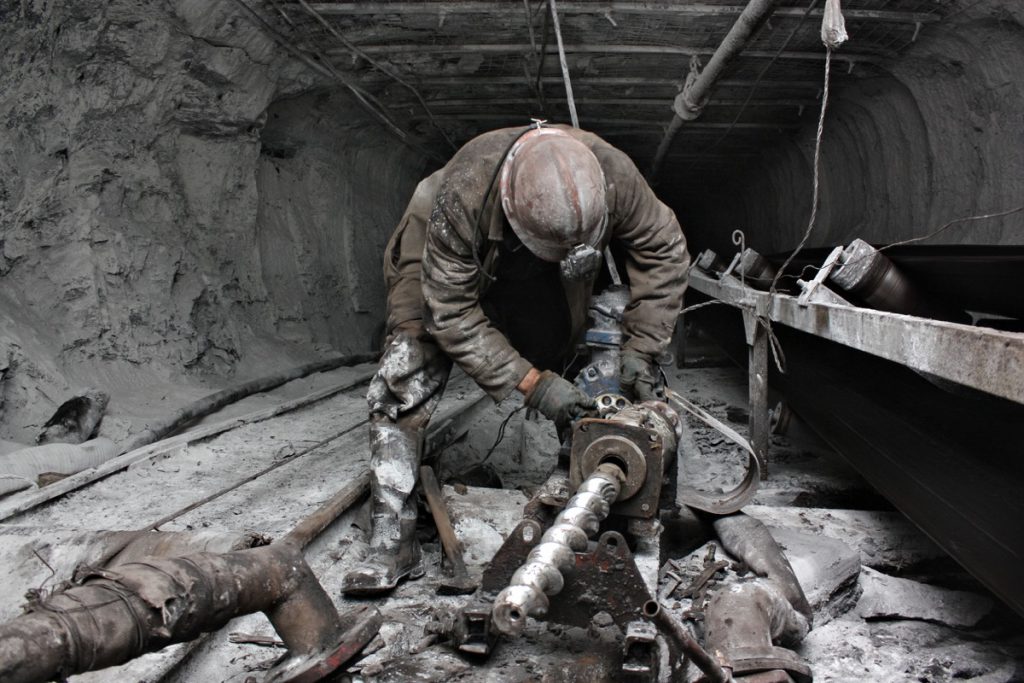 miner performs work in a mine