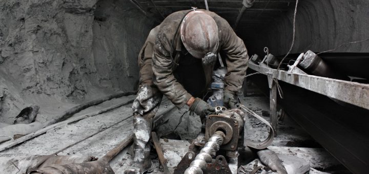 miner performs work in a mine