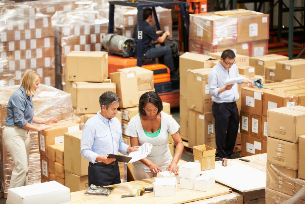 Workers In Warehouse Preparing Goods For Dispatch