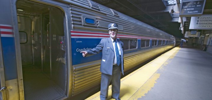 conductor at amtrak train platform announces ""all aboard"" at east coast train station on the way to new york city, new york, manhattan, new york