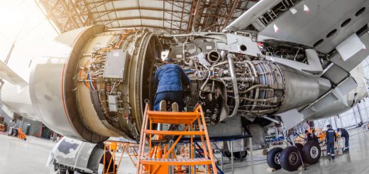 Specialist mechanic repairs the maintenance of a large engine of a passenger aircraft in a hangar