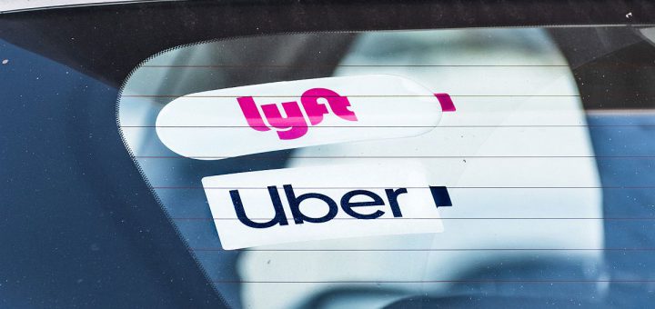 Dec 19, 2019 Redwood City / CA / USA - Lyft and UBER stickers on the rear window of a vehicle offering rides in San Francisco Bay Area