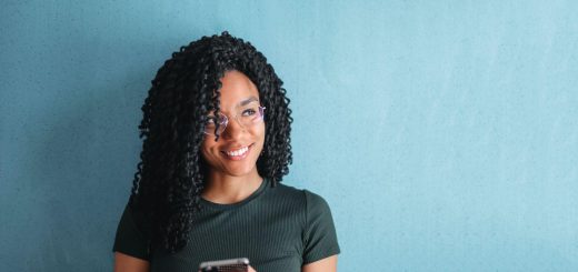 smiling woman using smartphone; informal online spaces concept