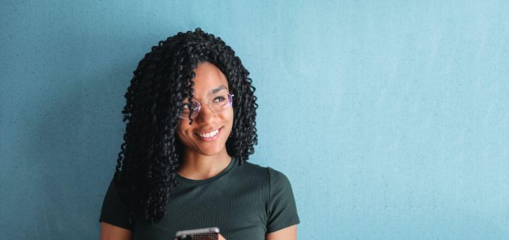 smiling woman using smartphone; informal online spaces concept