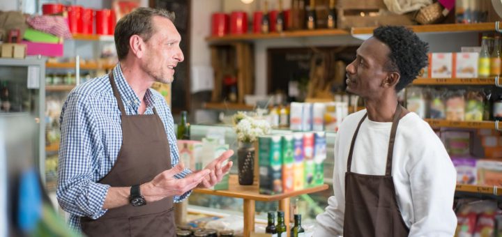 two grocery workers talking; collective bargaining concept