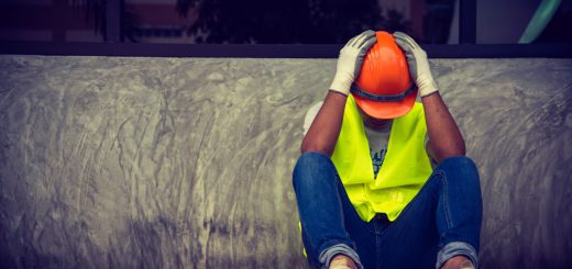 Construction worker sitting head in hands; right to work myth concept