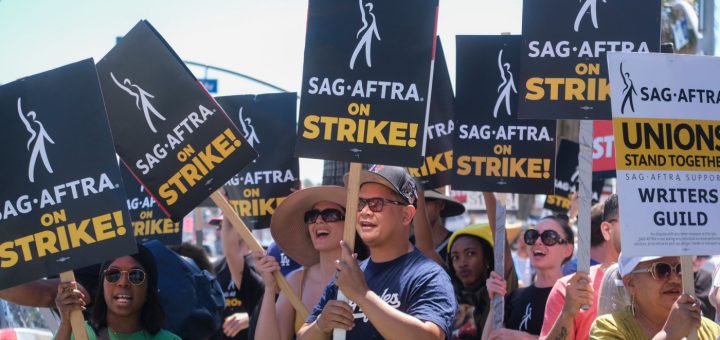 Striking writers and actors picketing; worker solidarity concept